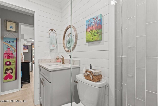 2632 Loopridge Dr, Orange Park, FL 32065 - full bathroom with toilet, wood finished floors, vanity, and wood walls