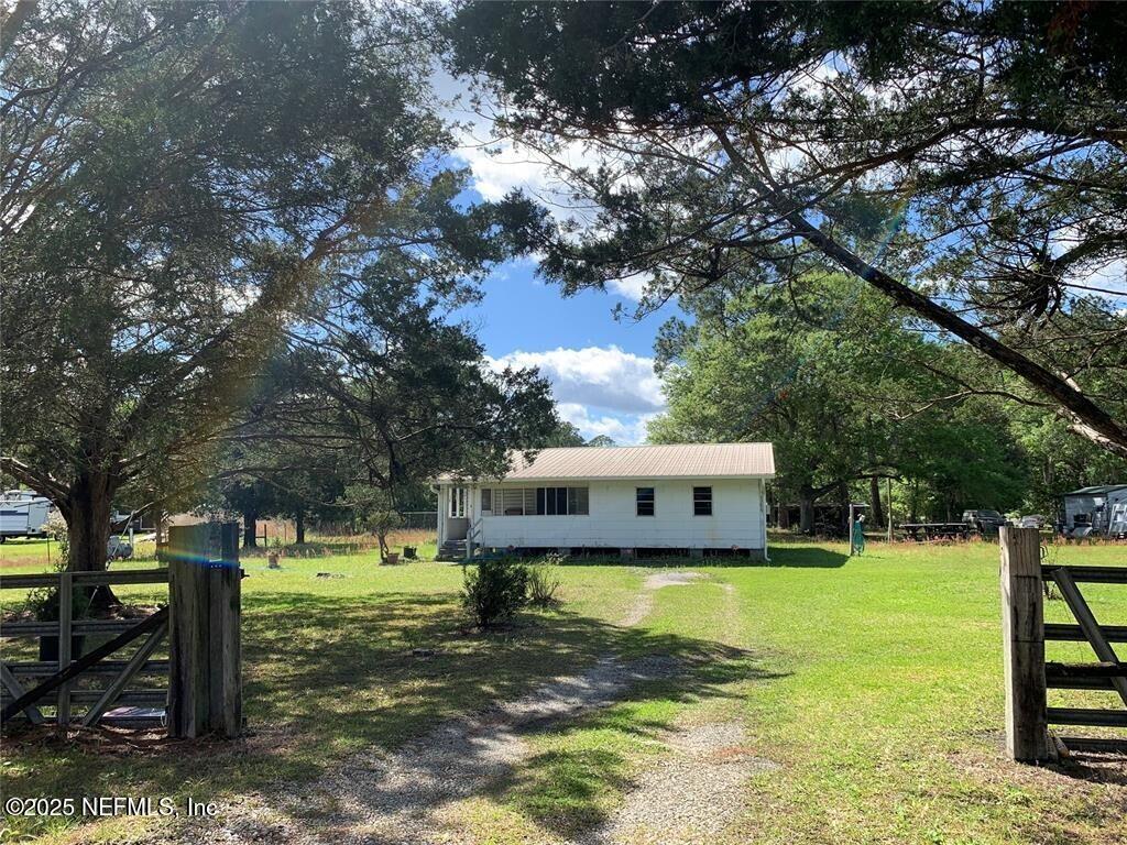 exterior space with fence and a lawn