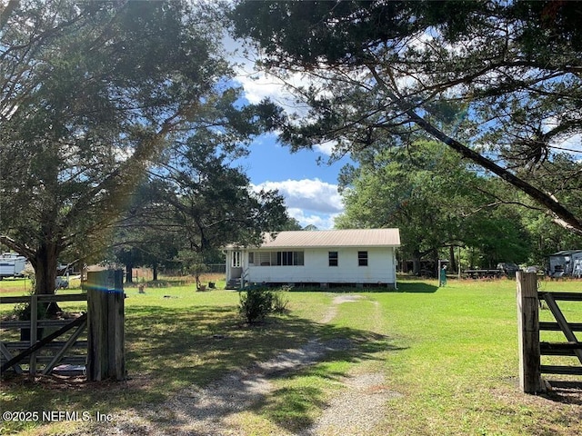 exterior space with fence and a lawn