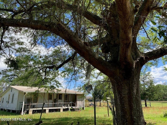 view of front of house with a porch and a front lawn