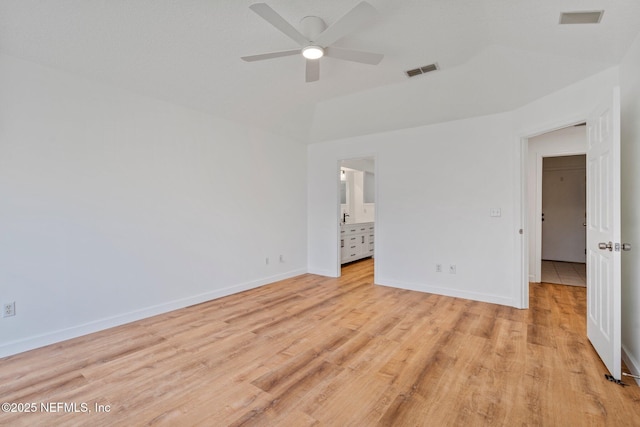 unfurnished bedroom featuring connected bathroom, light wood-type flooring, visible vents, and baseboards