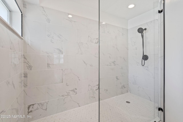 bathroom featuring walk in shower and recessed lighting