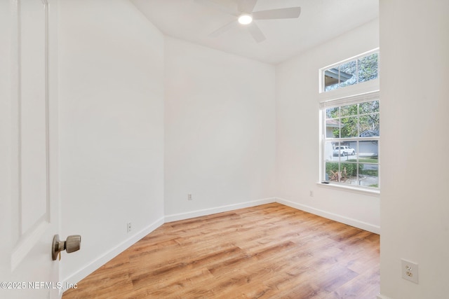 unfurnished room with wood finished floors, baseboards, and ceiling fan