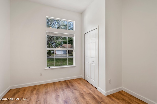 interior space with wood finished floors and baseboards