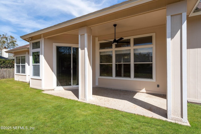 back of house with fence, a patio, a ceiling fan, and a lawn