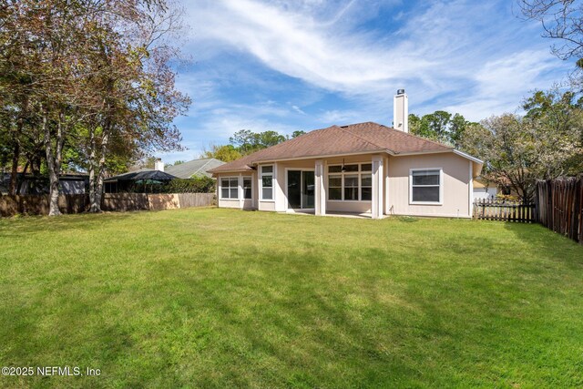 1856 Weston Cir, Fleming Island, FL 32003 - rear view of house with a yard, a chimney, and a fenced backyard