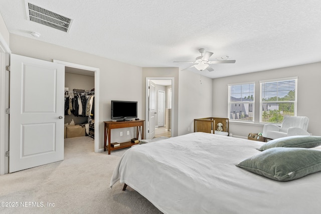 10350 Alder Creek Ln, Jacksonville, FL 32222 - bedroom featuring a walk in closet, light colored carpet, a closet, ceiling fan, and connected bathroom