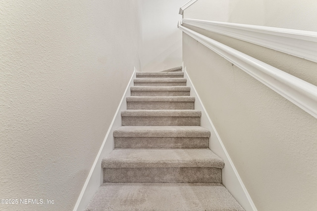 10350 Alder Creek Ln, Jacksonville, FL 32222 - stairway with a textured wall and baseboards