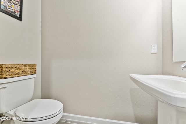 10350 Alder Creek Ln, Jacksonville, FL 32222 - bathroom featuring a sink, toilet, and baseboards