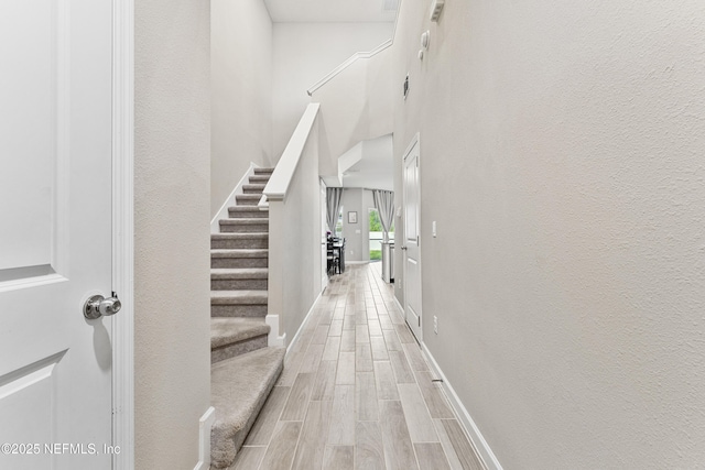 10350 Alder Creek Ln, Jacksonville, FL 32222 - hall featuring stairway, light wood-style floors, and baseboards