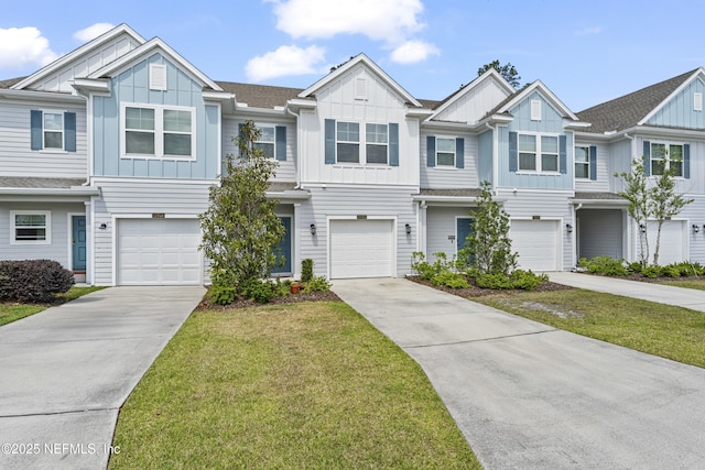 10350 Alder Creek Ln, Jacksonville, FL 32222 - townhome / multi-family property with board and batten siding, an attached garage, driveway, and a front lawn