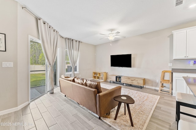 10350 Alder Creek Ln, Jacksonville, FL 32222 - living room featuring a ceiling fan, light wood finished floors, and baseboards