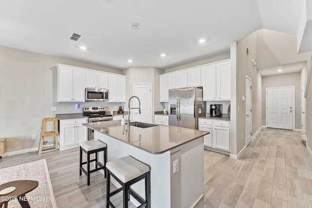 10350 Alder Creek Ln, Jacksonville, FL 32222 - kitchen featuring stainless steel appliances, a sink, light wood-style floors, a kitchen breakfast bar, and recessed lighting