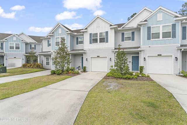 10350 Alder Creek Ln, Jacksonville, FL 32222 - townhome / multi-family property with board and batten siding, concrete driveway, and an attached garage