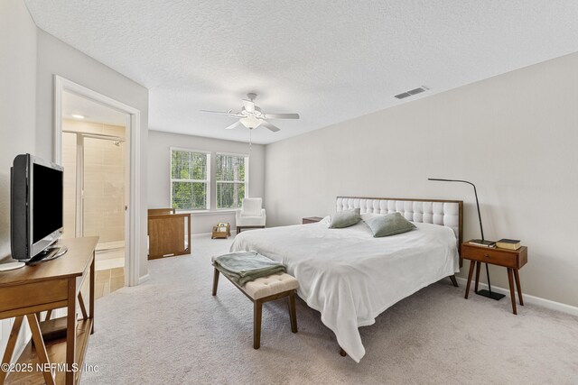 10350 Alder Creek Ln, Jacksonville, FL 32222 - bedroom with light carpet, baseboards, ceiling fan, connected bathroom, and a textured ceiling