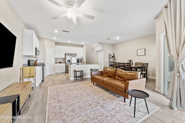 10350 Alder Creek Ln, Jacksonville, FL 32222 - living room with wood tiled floors, a ceiling fan, baseboards, and recessed lighting