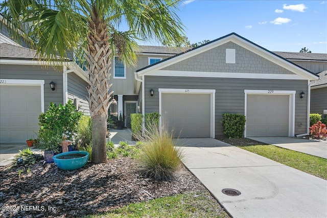 townhome / multi-family property with an attached garage and driveway