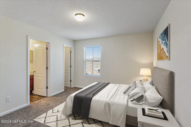 carpeted bedroom with a textured ceiling and baseboards