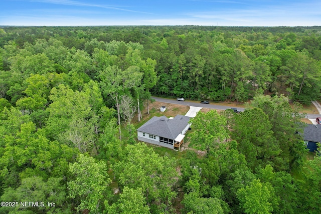 birds eye view of property with a forest view