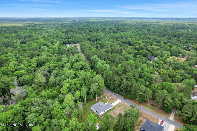 bird's eye view featuring a wooded view