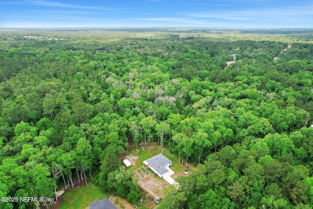 drone / aerial view with a wooded view
