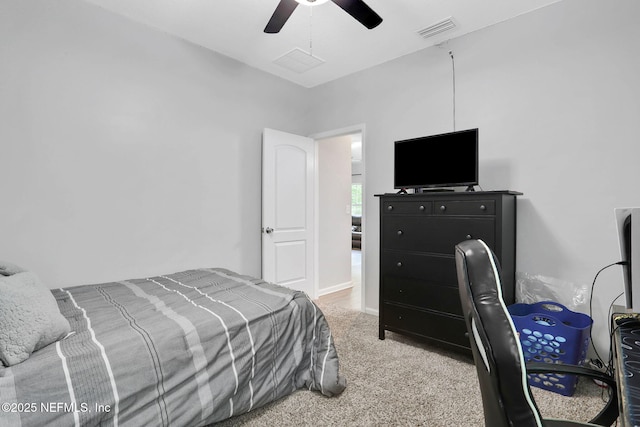 bedroom featuring visible vents, ceiling fan, and light carpet
