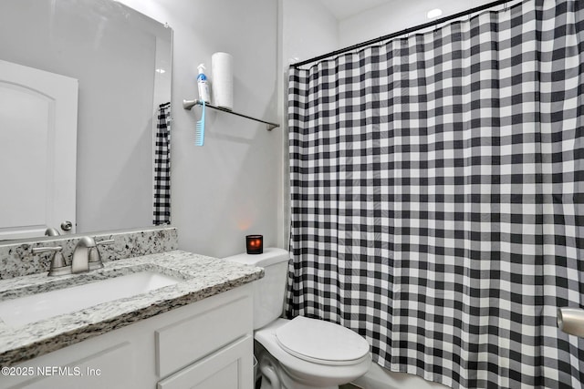 bathroom featuring toilet, a shower with curtain, and vanity