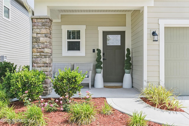 437 Narrowleaf Dr, Saint Johns, FL 32259 - property entrance with a porch, stone siding, and a garage