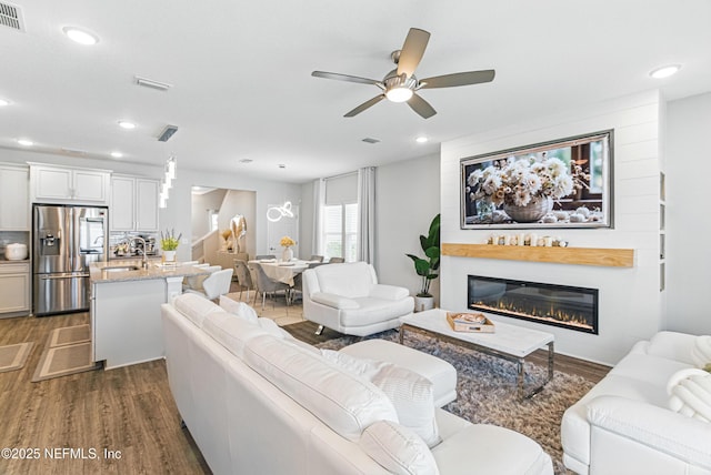 437 Narrowleaf Dr, Saint Johns, FL 32259 - living area featuring dark wood finished floors, ceiling fan, recessed lighting, and a glass covered fireplace