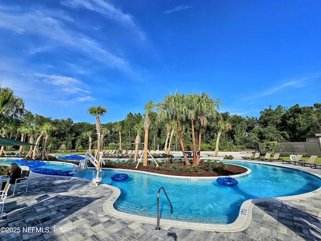 437 Narrowleaf Dr, Saint Johns, FL 32259 - community pool featuring a patio, fence, and view of scattered trees