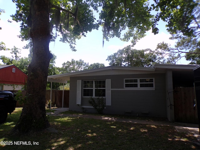 exterior space with concrete block siding and fence