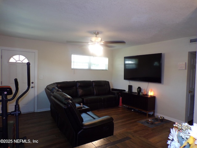 living room featuring baseboards, a ceiling fan, and wood finished floors