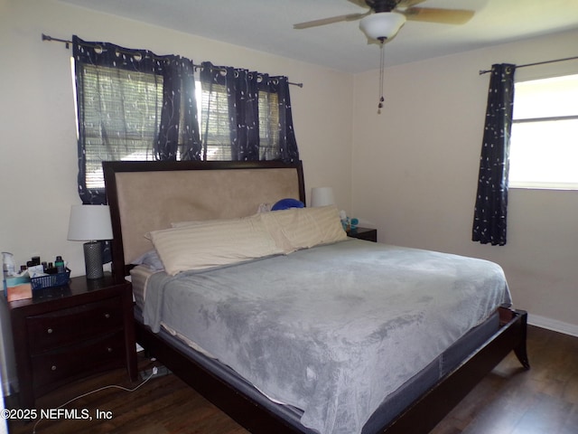 bedroom featuring a ceiling fan, wood finished floors, and baseboards