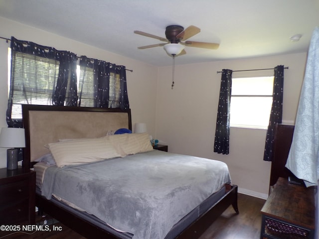 bedroom with baseboards, a ceiling fan, and wood finished floors
