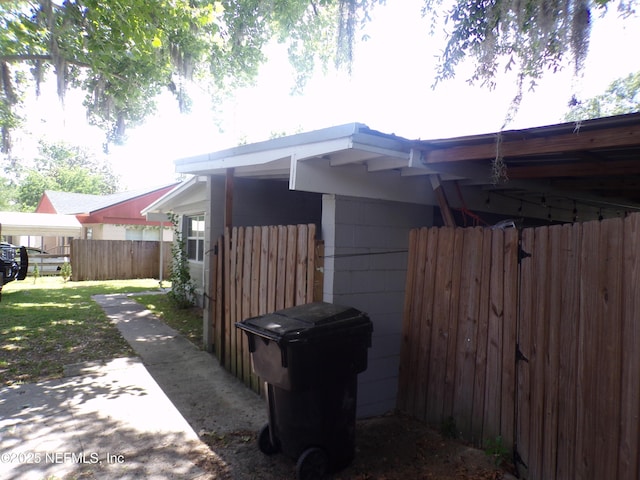 view of side of home featuring fence