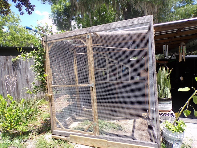 view of poultry coop featuring fence