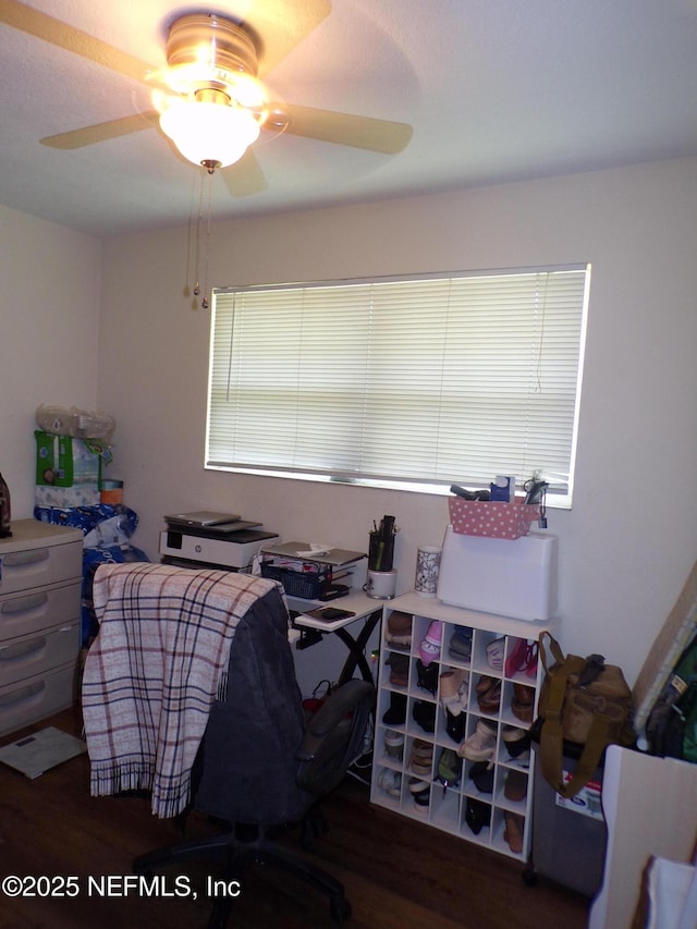 home office with wood finished floors and a ceiling fan