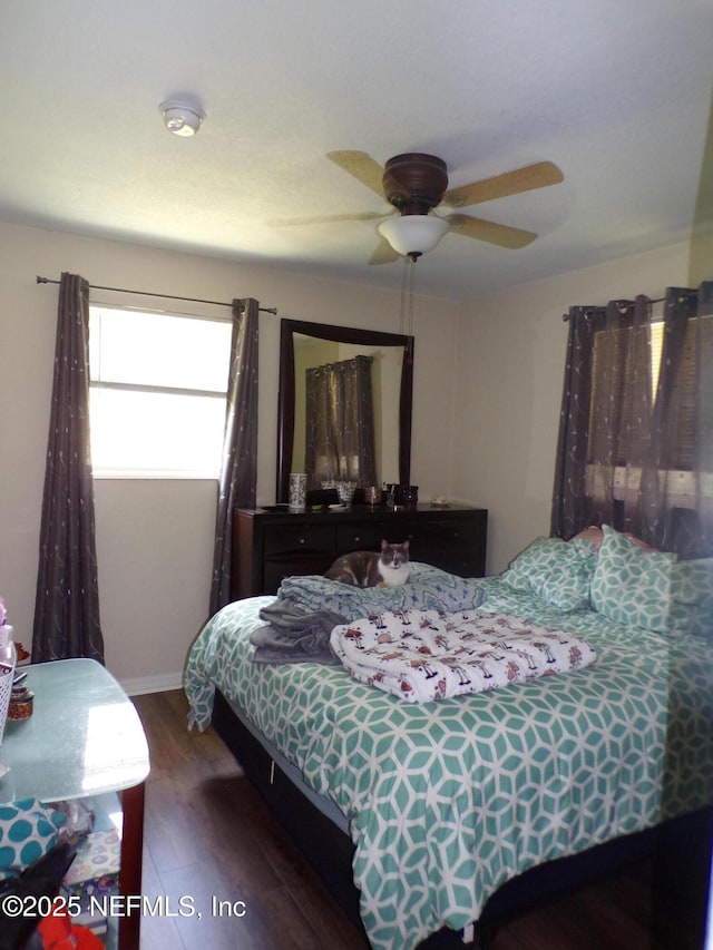 bedroom featuring a ceiling fan and wood finished floors