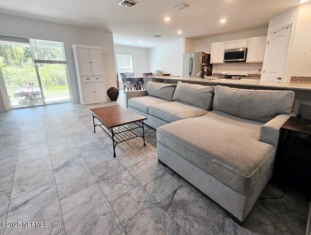 497 Live Oak Loop, Crescent City, FL 32112 - living room featuring marble finish floor, recessed lighting, and visible vents