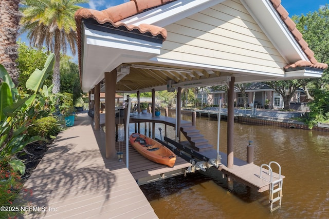 dock area featuring boat lift and a water view