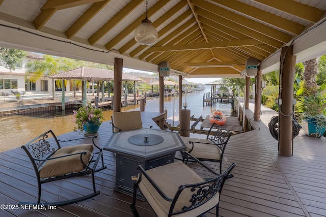wooden terrace featuring boat lift, a water view, and a boat dock