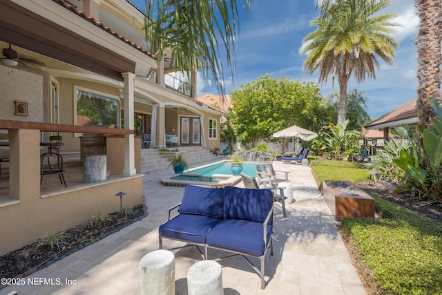view of patio / terrace featuring a ceiling fan, a balcony, french doors, outdoor lounge area, and an outdoor pool