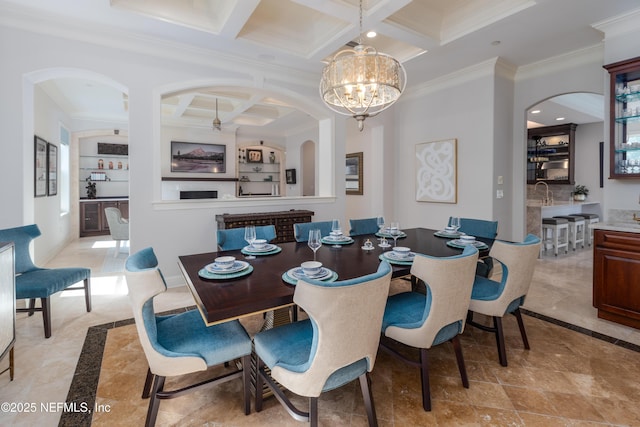 dining space featuring crown molding, coffered ceiling, beam ceiling, and arched walkways