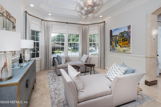 sitting room with a decorative wall, crown molding, a notable chandelier, and recessed lighting