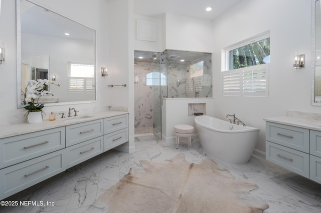 full bathroom featuring a marble finish shower, a wealth of natural light, marble finish floor, and a sink