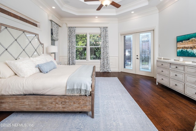 bedroom featuring french doors, ornamental molding, dark wood finished floors, access to outside, and a decorative wall