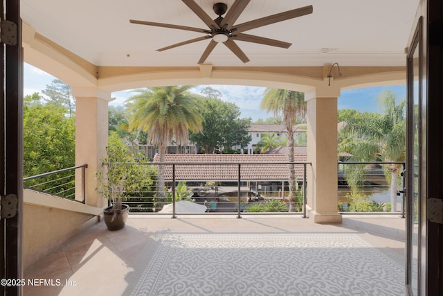 exterior space with a ceiling fan and a balcony