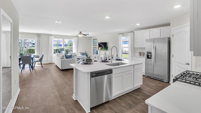 kitchen featuring dark wood-style flooring, a sink, light countertops, white cabinets, and appliances with stainless steel finishes