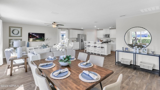 dining area with ceiling fan, plenty of natural light, and wood finished floors