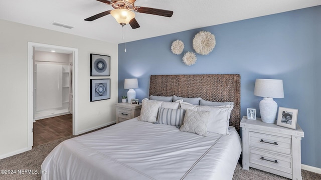carpeted bedroom with ensuite bathroom, baseboards, a ceiling fan, and visible vents